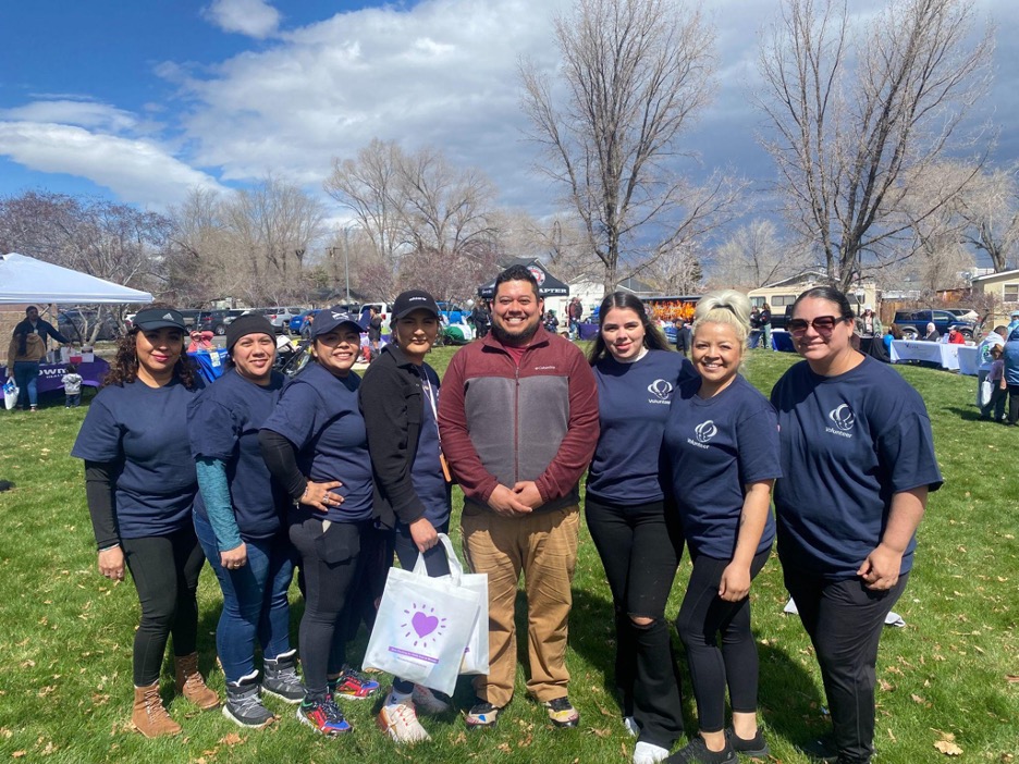 A group of adults all wearing matching tshirts pose for a photo at a Nevada Early Childhood Family Leadership Council event.