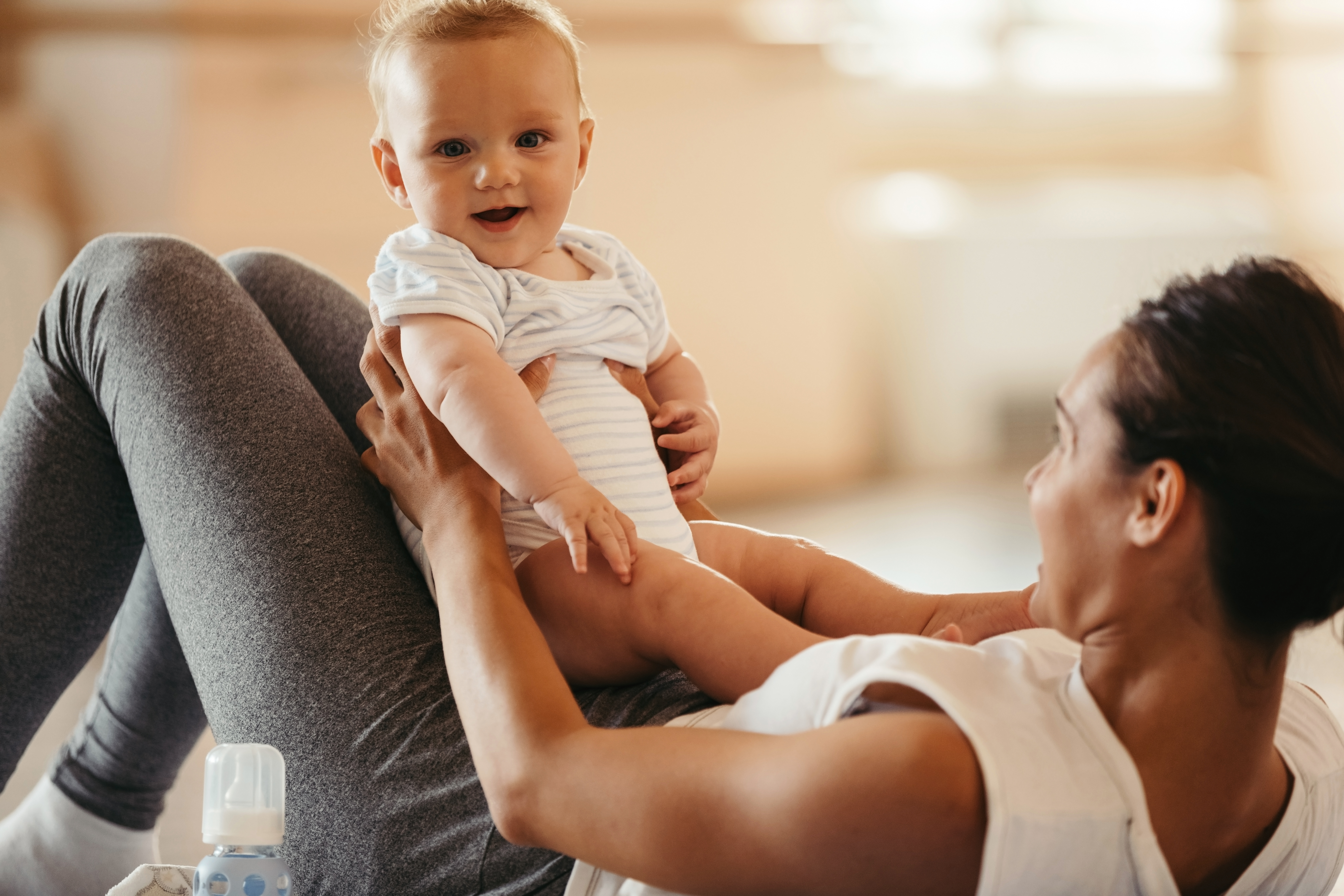 Smiling baby being held by women 