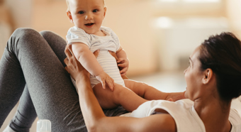 Smiling baby being held by women 