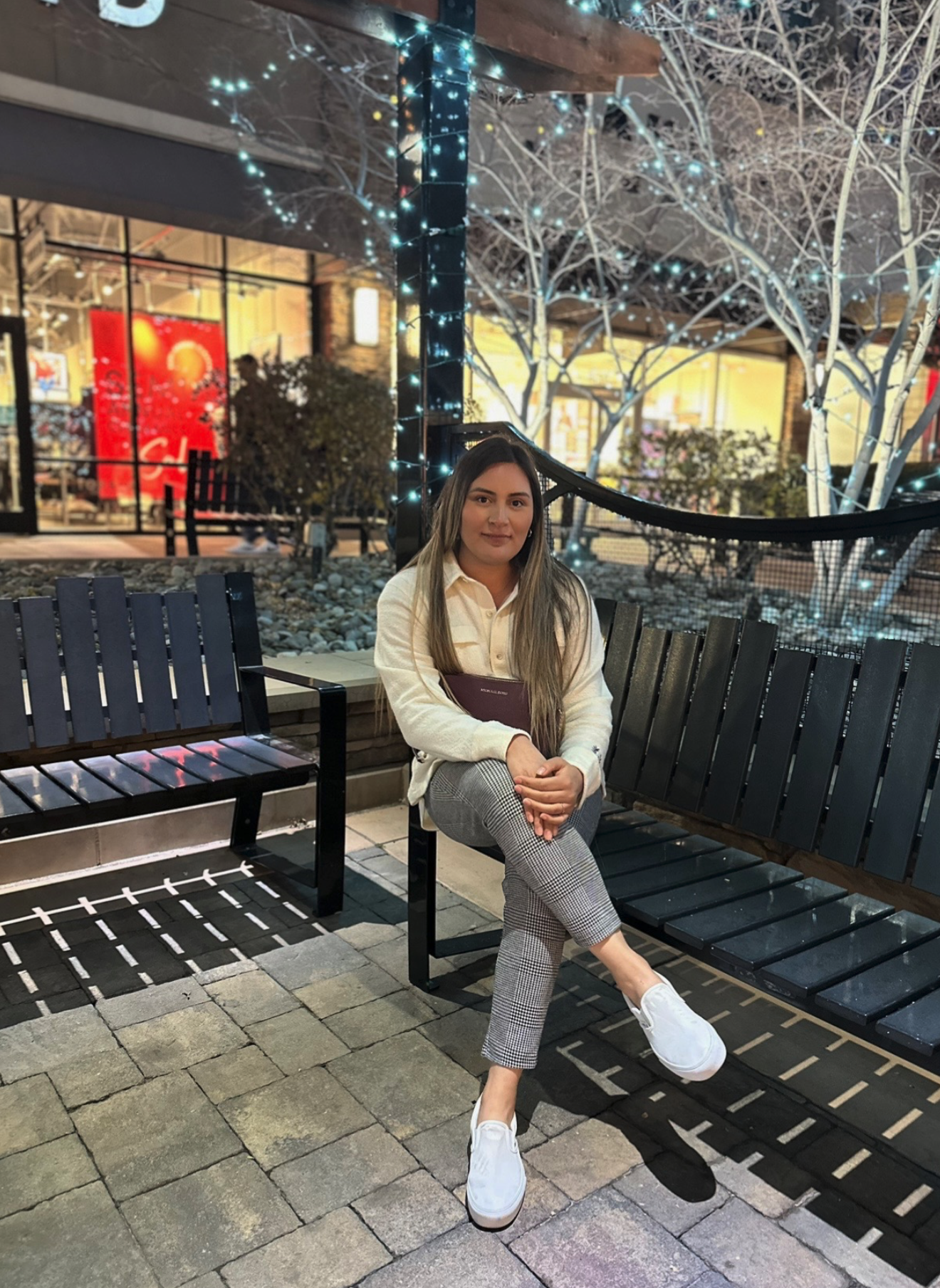 Alejandra Melecio looking at camera sitting on bench in an outdoor setting