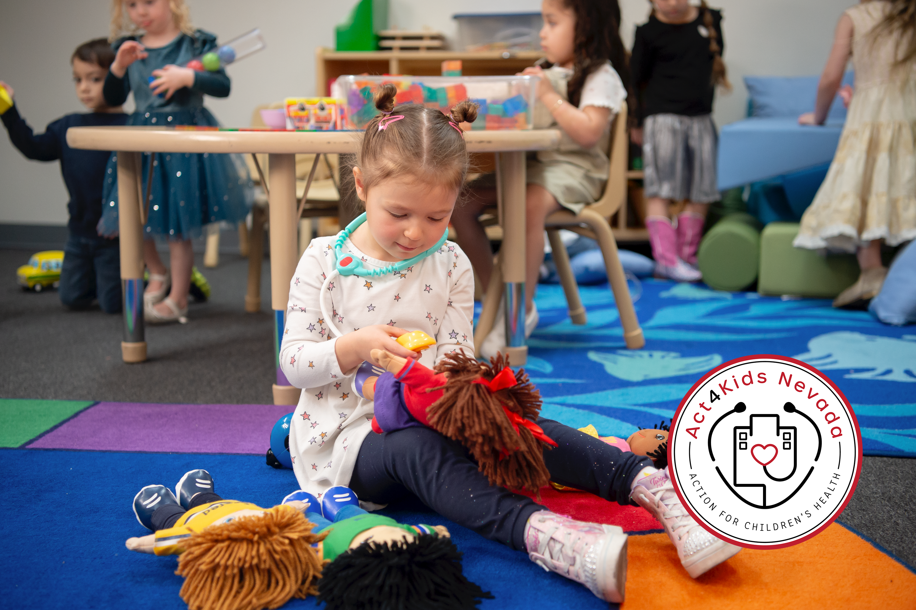 Little girl playing with dolls in a school setting with other kids 